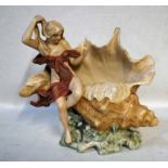 A Royal Dux porcelain figure of scantily clad maiden seated on a shell, holding a mirror whilst