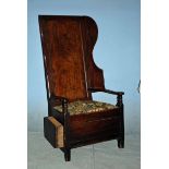 An 18th century Fruitwood and Oak Lambing or Shepherds Chair, panelled back with shaped wing