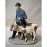 A Royal Copenhagen porcelain Figural Group as a young man leading two calves on halters, on oval