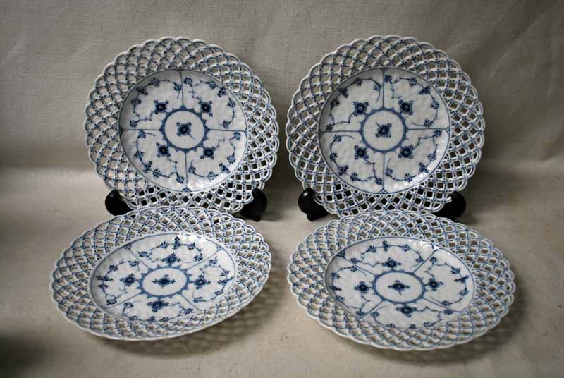 A set of four Royal Copenhagen blue and white plates, pierced lattice rim, decorated in Onion