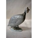 A Royal Copenhagen porcelain model as a Guinea Fowl on oval naturalistic base, printed factory