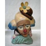 A Lladro pottery bust as a Pensive Clown wearing a bowler hat, his chin resting on crossed hands,