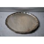 An early 20th century silver three-footed Tray by Mappin and Webb, shaped circular form with