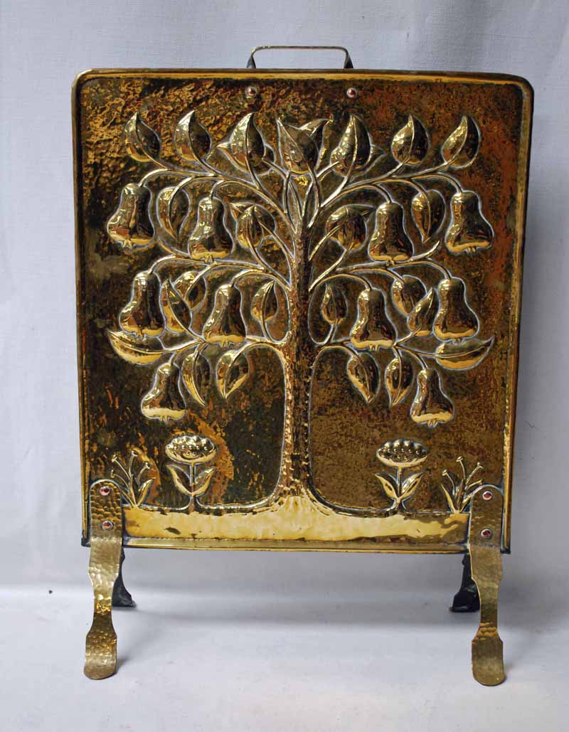 A good Arts and crafts planished brass Fire Screen, embossed with an organic decoration depicting