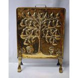 A good Arts and crafts planished brass Fire Screen, embossed with an organic decoration depicting