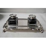 An early 20th century silver Desk Stand, four footed, of shaped rectangular form with reeded edge,