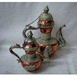 A Tibetan copper, brass and silvered Milk Tea Tea Pot, embossed with foliate and other devises,