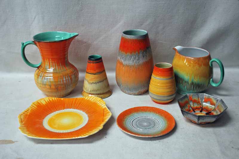 Shelley Drip Ware, orange and green, orange and brown, two Jugs, 13.5cm and 18.5cm, three Vases,