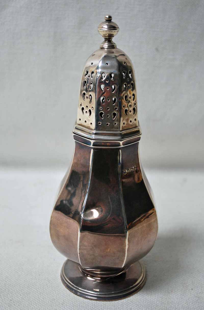 An Edwardian silver Sugar Caster of octagonal baluster form, pierced cover with knop, on raised