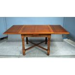 An early 20th century oak Draw Leaf Dining table by Waring and Gillows, square top above beaded