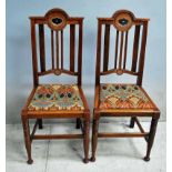 A good set of four Arts and Crafts oak Dining Chairs, arched back rail incorporating silver metal