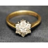 An 18ct gold and diamond set Cluster Ring, the seven stones arranged in a typical daisy style