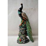 Minton in Miniature, a majolica style model of a Peacock on a tall naturalistic base 26cm high