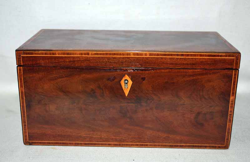 A 19th century line inlaid mahogany Tea Caddy of rectangular form, hinged lid enclosing a central