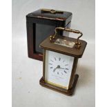 A brass Carriage Clock by Mathew Norman in leather travel case, white enamel dial and platform