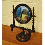 A Georgian Gentleman's Shaving Mirror, having a circular adjustable bevelled plate, turned columns