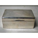 An early 20th century silver Cigarette Box, rectangular cushion top form with hinged cover and