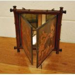 An Oriental triple folding Mirror, the mirror is enclosed within a turned wood simulated bamboo