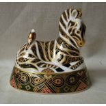 A Royal Crown Derby Desk Weight as a recumbent Zebra, silver stopper, 14.5cm long