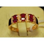 An 18ct yellow gold ruby and diamond ring, band setting alternate ruby and diamond, size U
