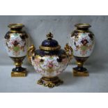 A late Victorian Royal Crown Derby Garniture consisting of a covered and footed two-handled vase