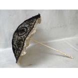 A Victorian Chantilly Lace Mourning Parasol, with full length carved ivory handle, the grip having