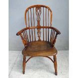 A 19th century yew and elm Windsor Arm Chair, hooped back and arms, spindled back and sides, central