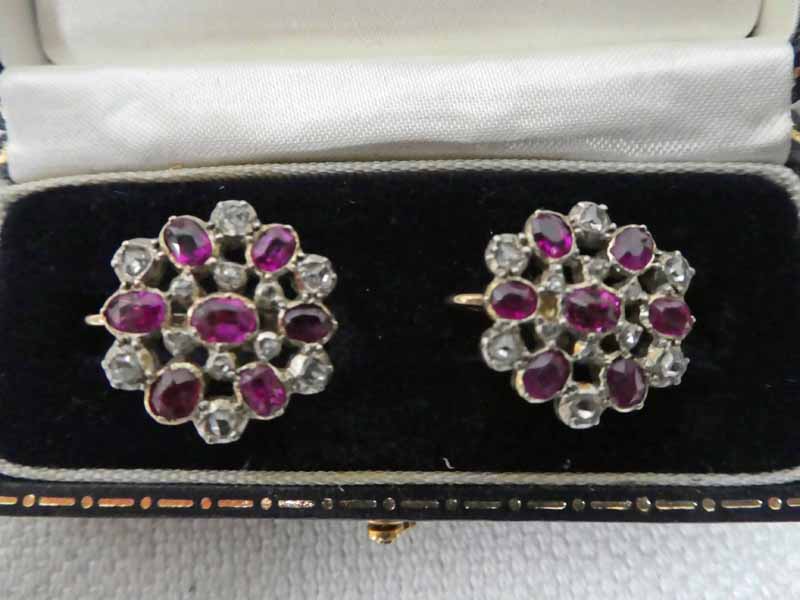 A pair of early 20th century, gold, diamond and ruby set screw back earrings, target style with