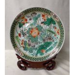 A large Chinese 19th century Dish, Famille Verte, decorated in polychrome enamels with exotic