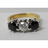 An 18ct gold three-stone sapphire and diamond Ring, central brilliant cut diamond approx 0.4ct