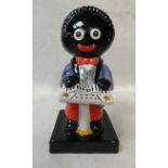 A Carlton Ware Golly figure in red, white and blue playing a keyboard, printed factory mark and