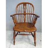 A 19th century ash and elm low back Windsor Arm Chair, hooped back and arms, spindled back and