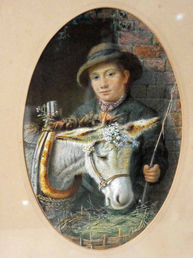 R P Richards (British 19th century), Boy with a Donkey, signed watercolour in oval mount, 22cm by