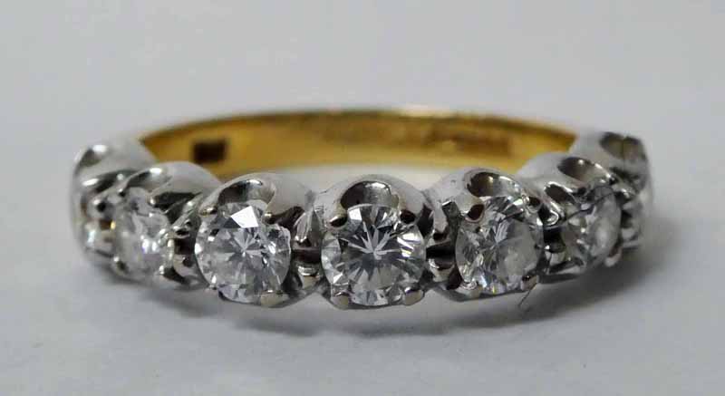 An 18ct gold and diamond Half Eternity Ring, seven brilliant cut stones in four claw white gold