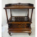 A Victorian walnut two-tier Canterbury, fretwork pierced low gallery on rectangular top shelf,