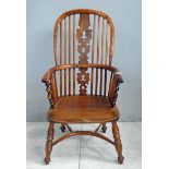 A 19th century yew and elm Windsor Arm Chair, hooped back and arms, spindle back and sides, turned