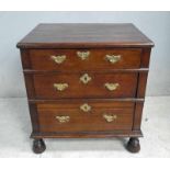 An 18th century oak Chest of three graduated Drawers, on later turned mallet head front legs and