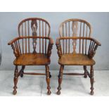 A pair of 19th century ash and elm low back Windsor Arm Chairs, hooped back and arms, spindled