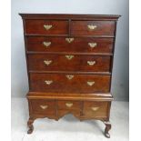 An 18th century oak Chest on Stand, moulded rectangular top over an arrangement of two short above