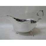 An Edwardian silver Sauce Boat of typical three-footed form, shaped edge, scroll handle,