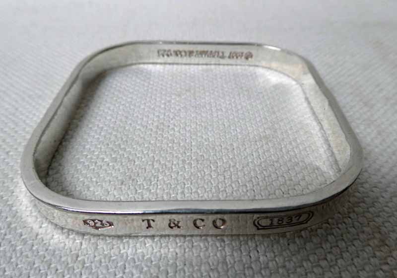 A square form silver Bangle with concave edge, marked T&Co 1837, 925