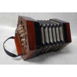 A Concertina by Lachenal, number 75414, hexagonal with wooden pierced ends with twenty-one
