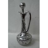 A continental Art Nouveau silver overlaid Claret Jug, typical form with overlaid pommel top stopper,