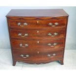 A good George III inlaid flame mahogany Bow Front Chest of four graduated cock beaded drawers,