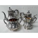 A mid-19th century silver four-piece Tea Service, by Elkington and Co, pear form, embossed panels of