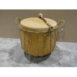 A Tribal Drum with carved wooden body, stretched animal felt for the drum skin with a single leather