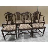 A set of seven Hepplewhite style mahogany Dining chairs including a single Carver, shaped pierced