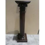 A stained sycamore pedestal formed as a Corinthian column on a square base with a square top, 34cm