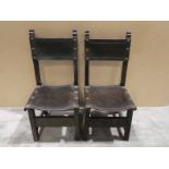 A pair of Dining Chairs with studded saddle leather seats and backs, carved front stretchers