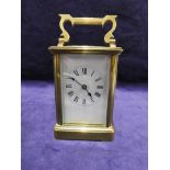 A mid 20th century French brass cased Carriage Clock, eight day movement, white dial with Roman